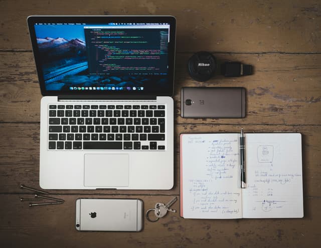 Man in Hoodie Sweater Using a Laptop