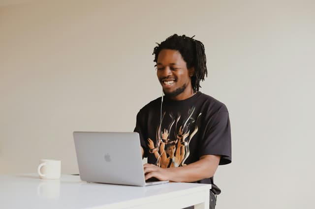 Man in Hoodie Sweater Using a Laptop